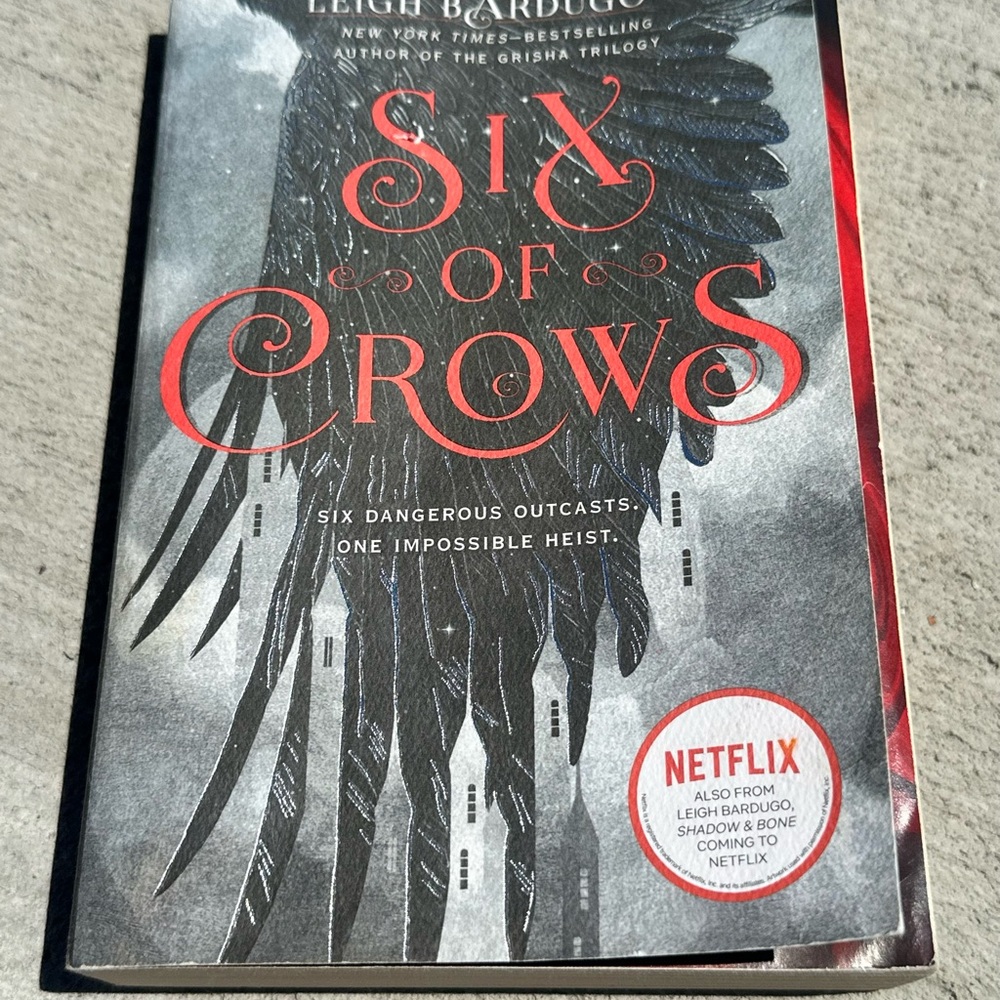 Six of Crows Paperback Novel with Black & Red Cover